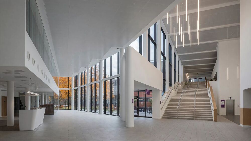 Entrance atrium - full-height glazing, reception desk and feature stair
