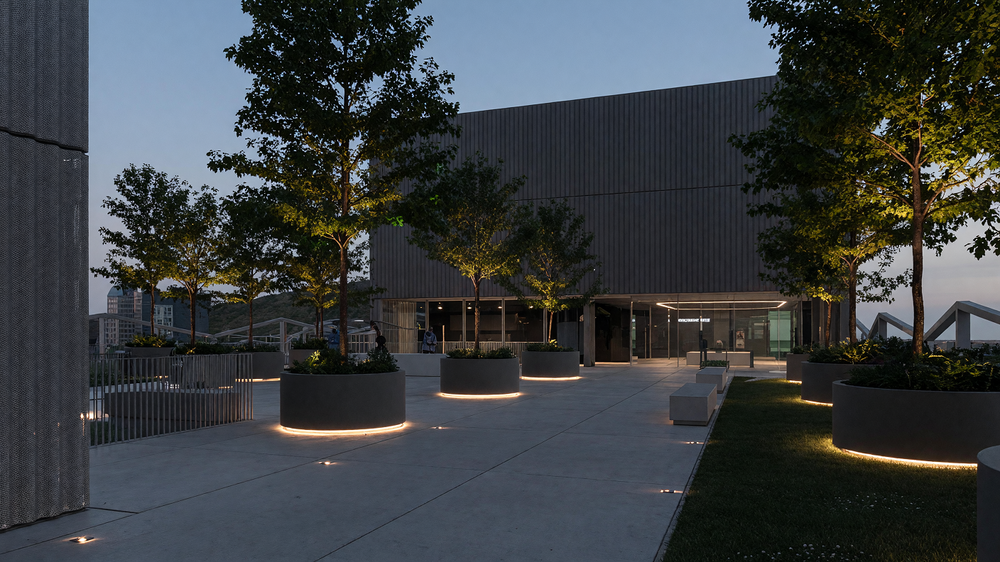 Roof terrace at dusk - lit planters, trees and paving
