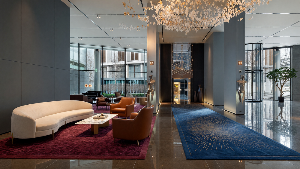 Residents lobby - stone walls, polished floor, seating and lift portal