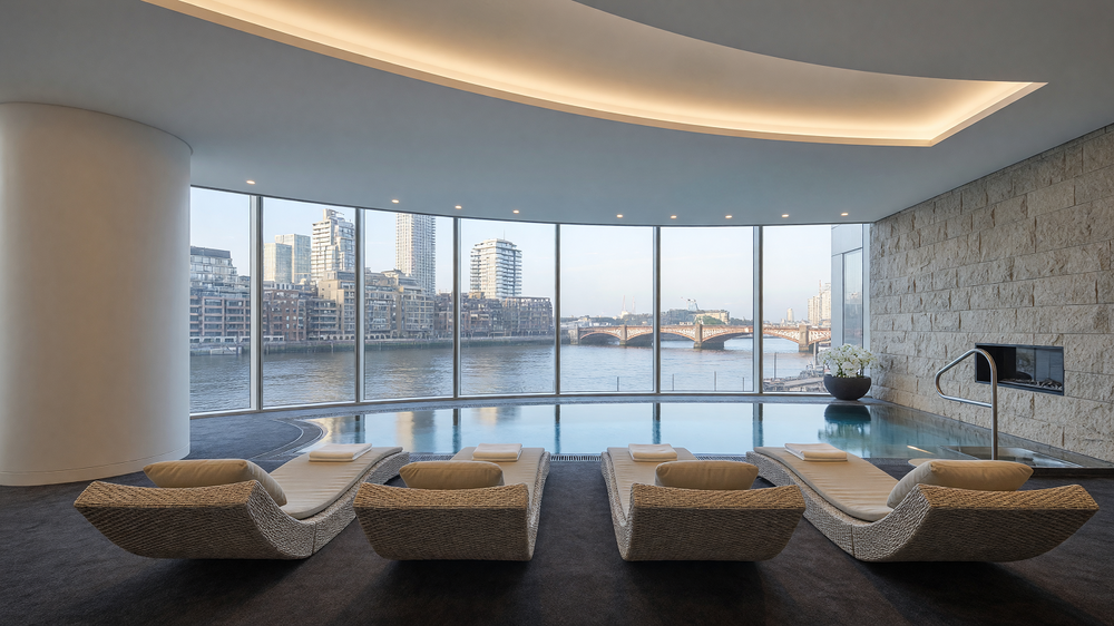 Pool and spa - curved cove ceiling, river view and stone wall