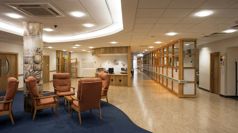 Ward reception and day room - seating, reception desk and corridor beyond