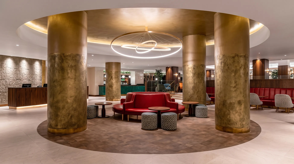 Lobby and reception - brass columns, circular gold ceiling raft and red banquette