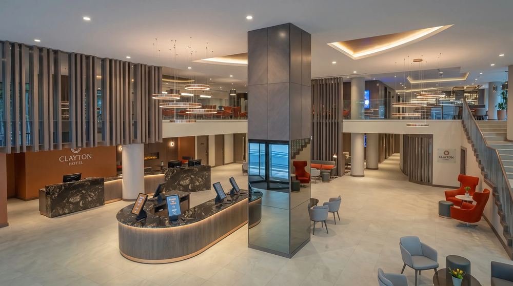 Lobby and reception - ring pendant clusters, check-in desk and mezzanine above