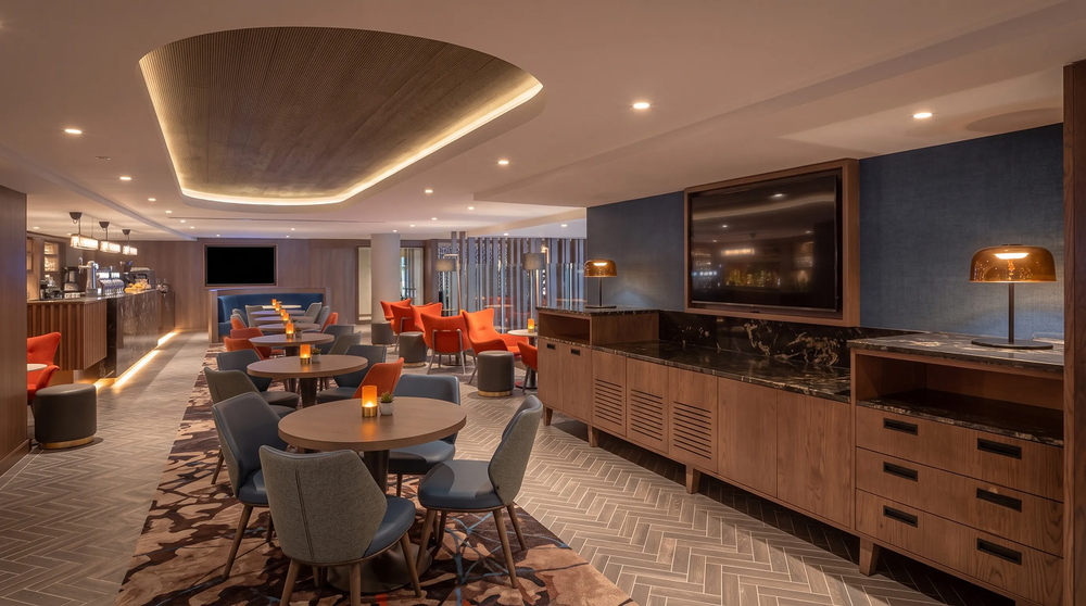 Lounge and bar - ribbed circular ceiling raft, seating and bar beyond